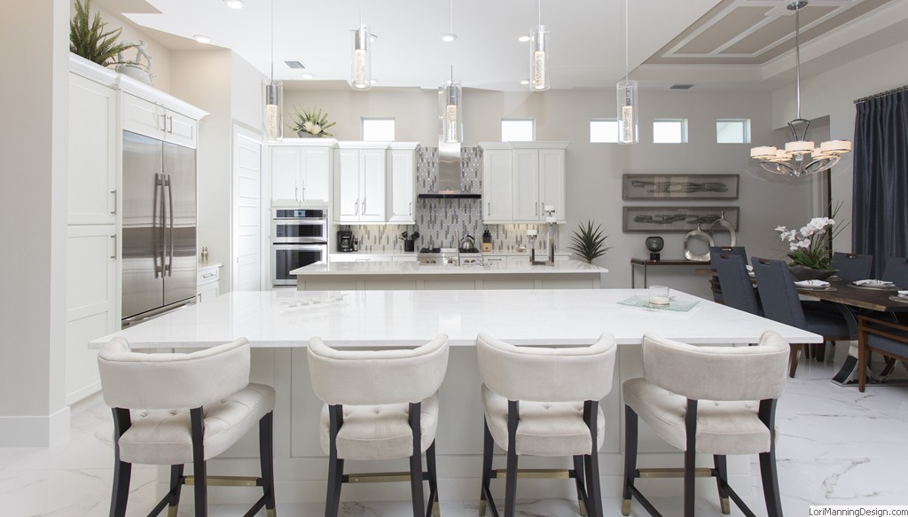 Kitchen white cabinets, double island, waterfall edge, staggered lighting