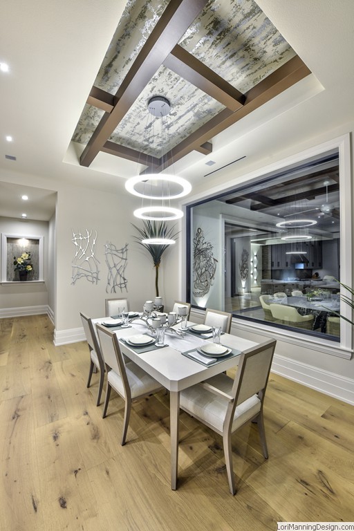 Dining Room features metal wall art, custom tray ceiling, circular lights, Bernhardt table