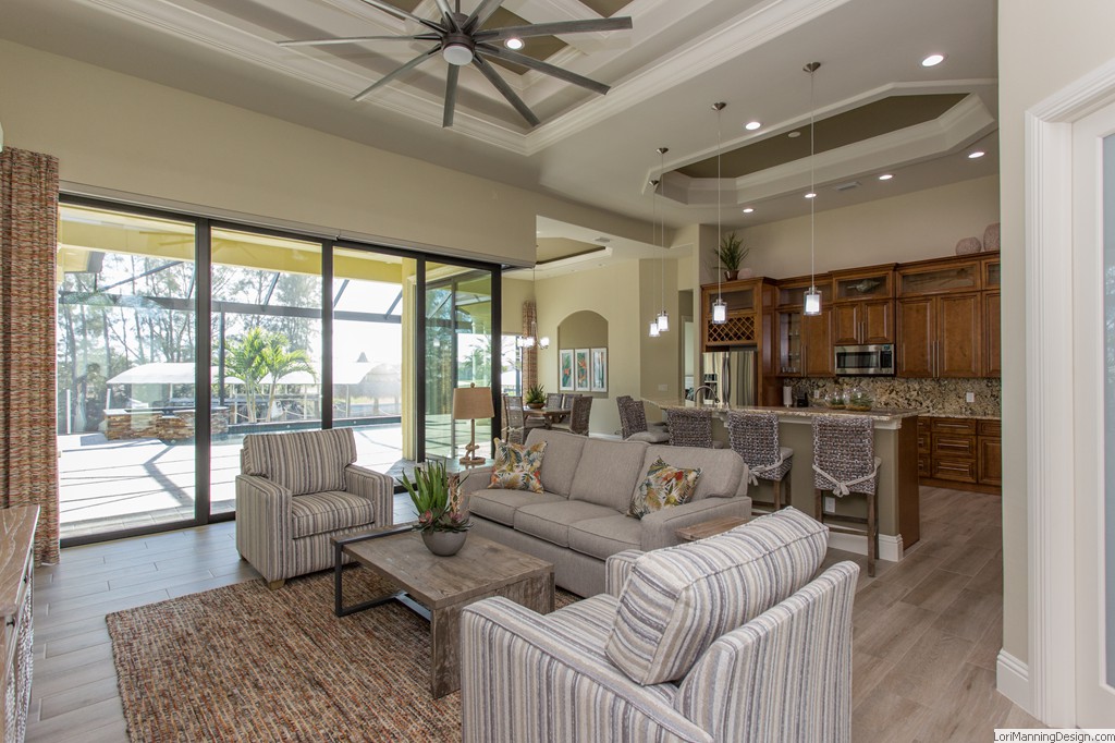 Living Room features orange accents, open concept, cozy, custom draperies, custom blinds