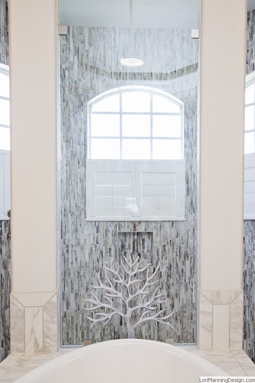 Etched glass shower wall keeps special tilework visible