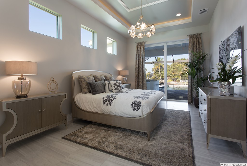 Master Bedroom features gold and silver sleigh bed, Two-toned nightstands, custom bedding